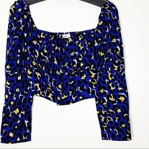 RAHI crop top. Blue with black and yellow print.